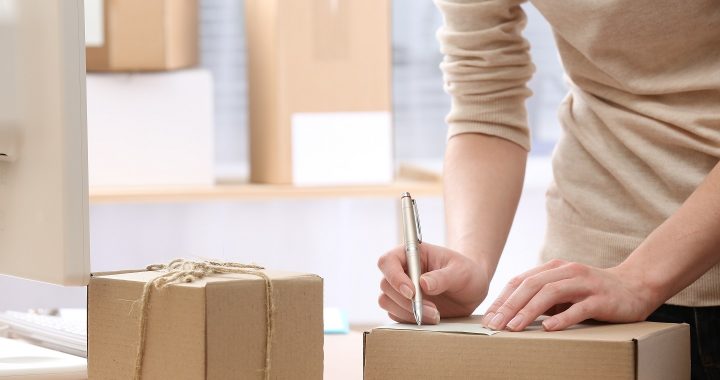 Woman signs parcel in post office